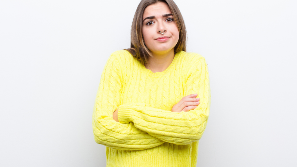 woman shrugging in yellow