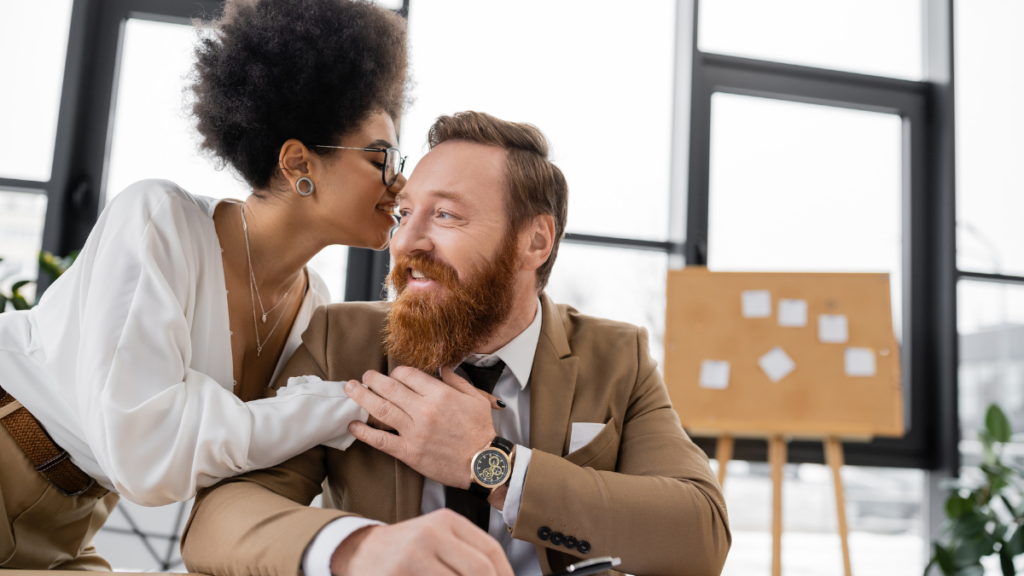 woman whispering in man's ear