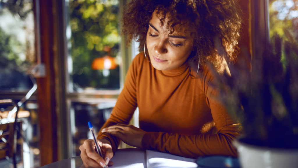 woman writing in notebook